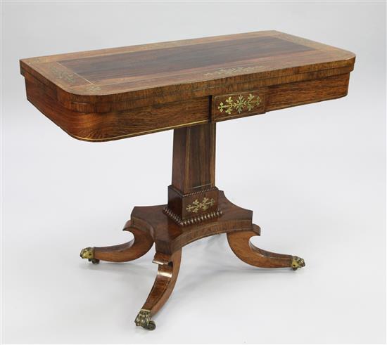 A Regency rosewood and brass inlaid fold over card table, 3ft x 1ft 5.5in. x 2ft 4.5in.